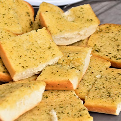 Garlic bread on top of a wooden table